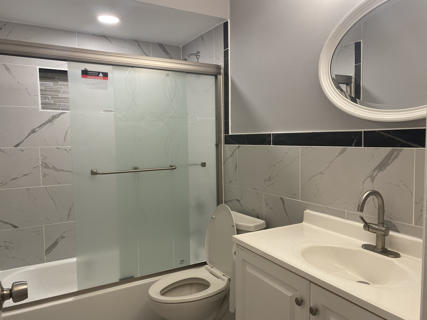 1710 Felten Road, Unit 1B Aurora, IL 60505 - Photo 7 of 14 a bathroom with a sink a toilet and a shower