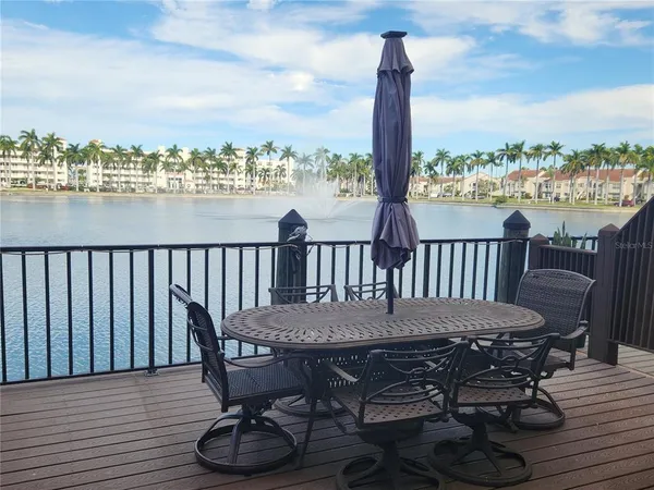 a view of a deck with furniture and city view