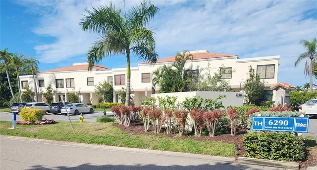 a front view of a house with garden and sitting area