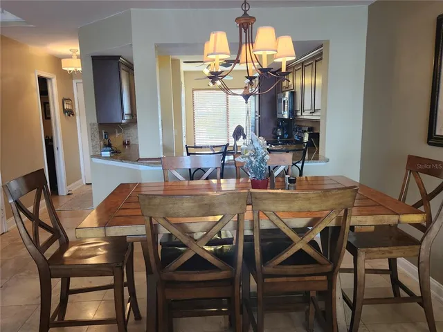 a view of a dining room with furniture and a chandelier