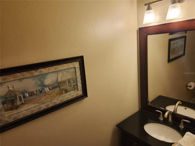 a bathroom with a sink mirror and vanity