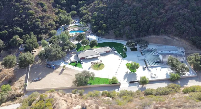 a aerial view of a house with a yard balcony