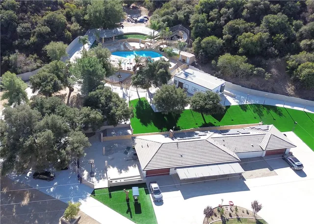an aerial view of a house with yard swimming pool and outdoor seating