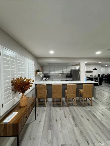 a large kitchen with a center island and stainless steel appliances