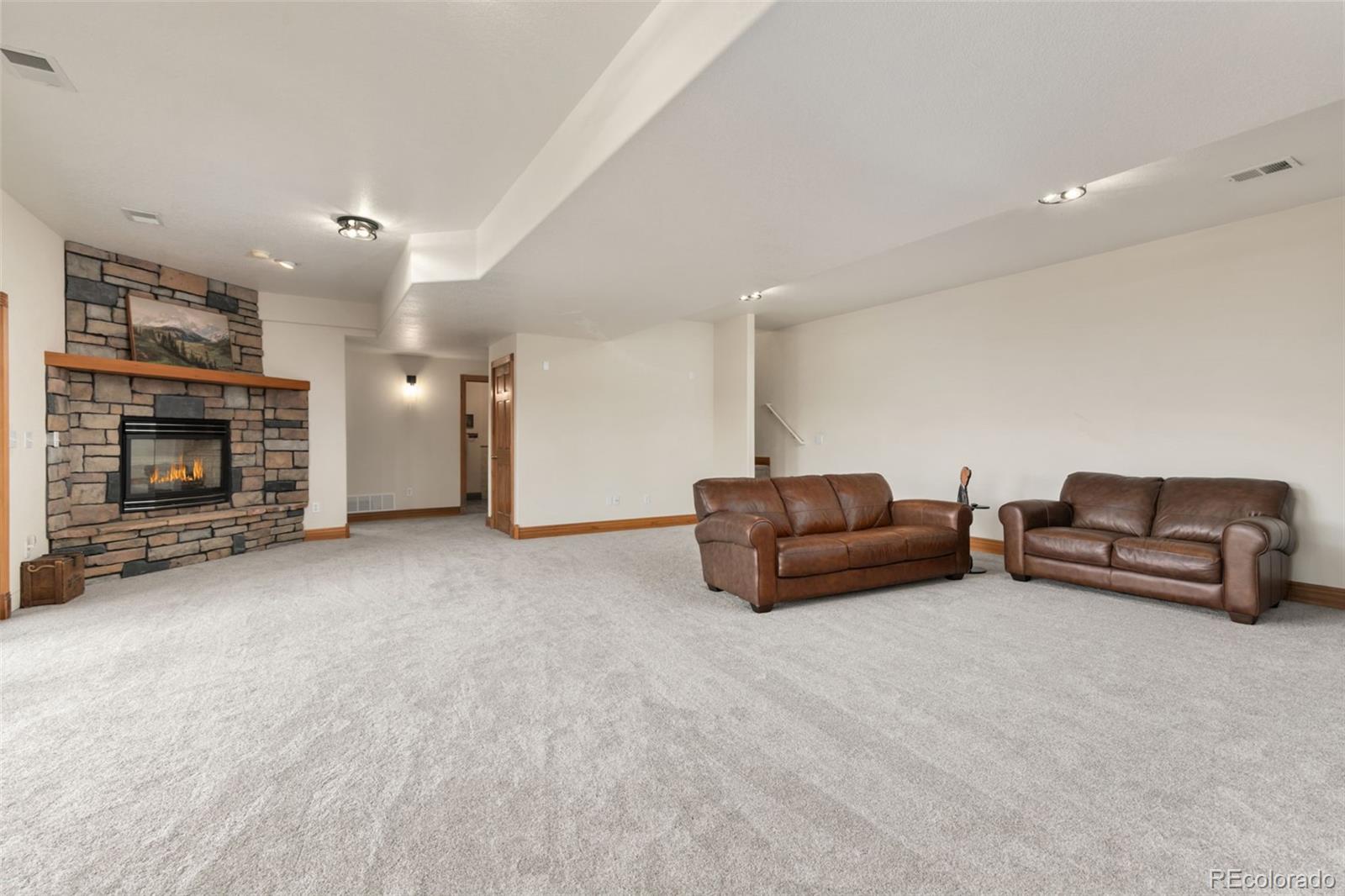 3065 Wildes Road Loveland, CO 80538 - Photo 18 of 42 a living room with furniture and a fireplace