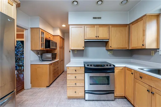 a kitchen with stainless steel appliances granite countertop a stove and a refrigerator