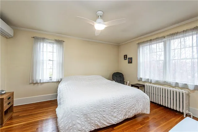 a bedroom with a bed and a flat tv screen on the dresser