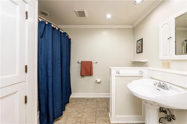 a bathroom with a sink and mirror with toilet