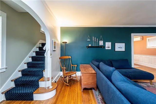 a living room with furniture and a potted plant