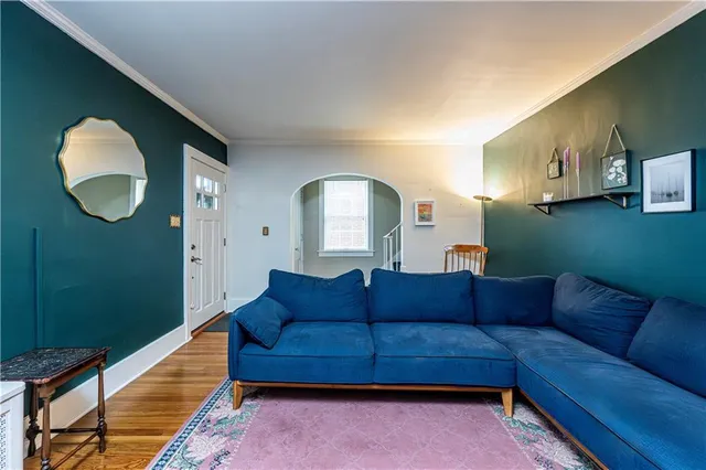 a view of a livingroom with furniture a fireplace and windows