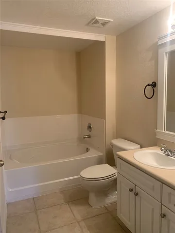 a bathroom with a toilet a sink a mirror and shower