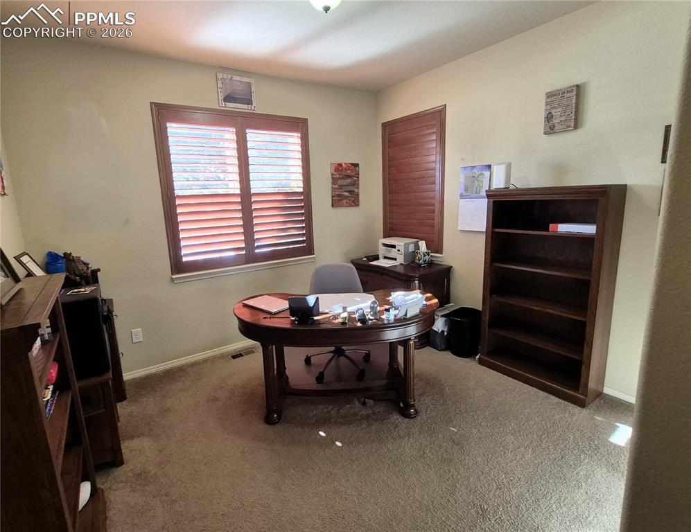 7619 Eagle Feather Point Colorado Springs, CO 80923 - Photo 12 of 23 a living room with furniture and a window