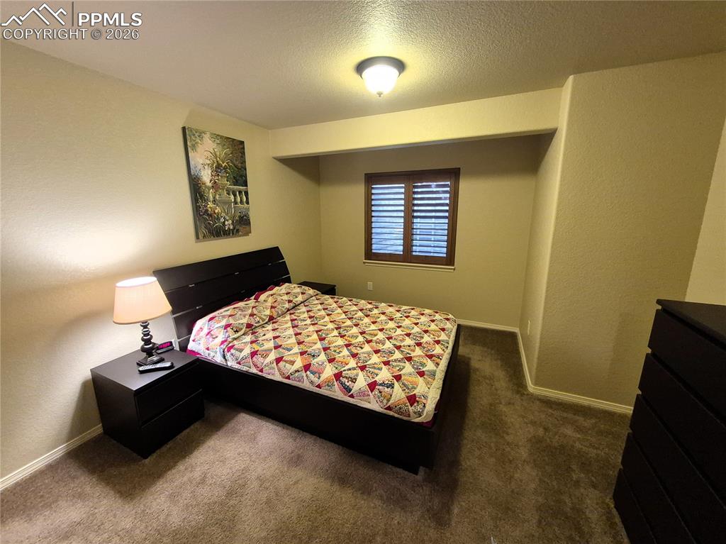 7619 Eagle Feather Point Colorado Springs, CO 80923 - Photo 17 of 23 a bedroom with a bed and a window