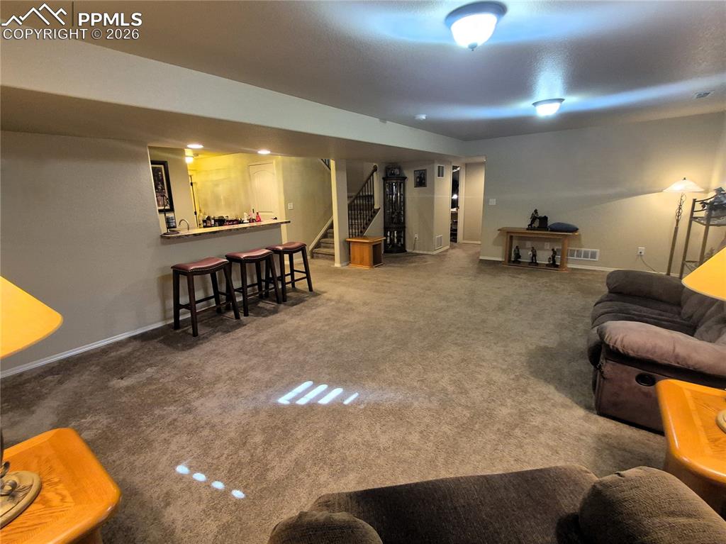 7619 Eagle Feather Point Colorado Springs, CO 80923 - Photo 19 of 23 a living room with furniture and a dining table