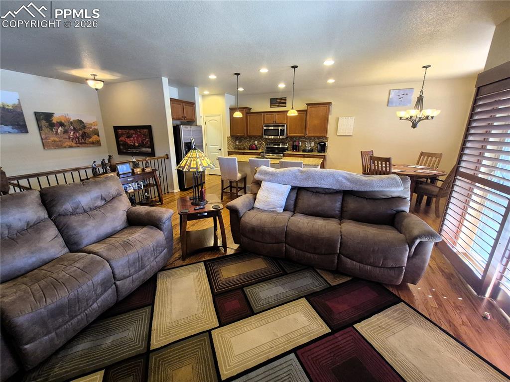 7619 Eagle Feather Point Colorado Springs, CO 80923 - Photo 6 of 23 a living room with furniture and kitchen view