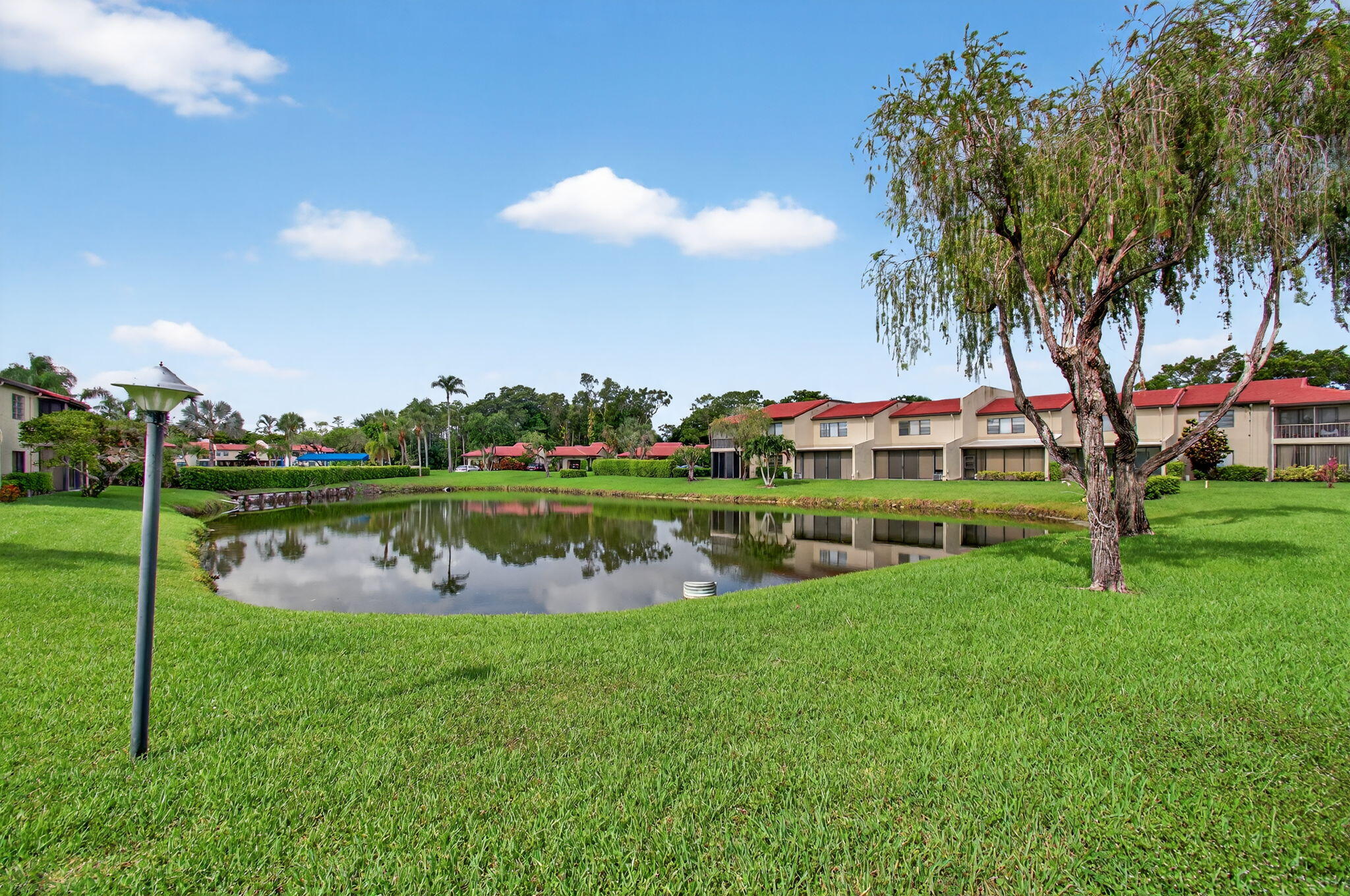 8536 Casa Del Lago, Unit 49B Boca Raton, FL 33433 - Photo 48 of 79 a view of a lake with houses in the background