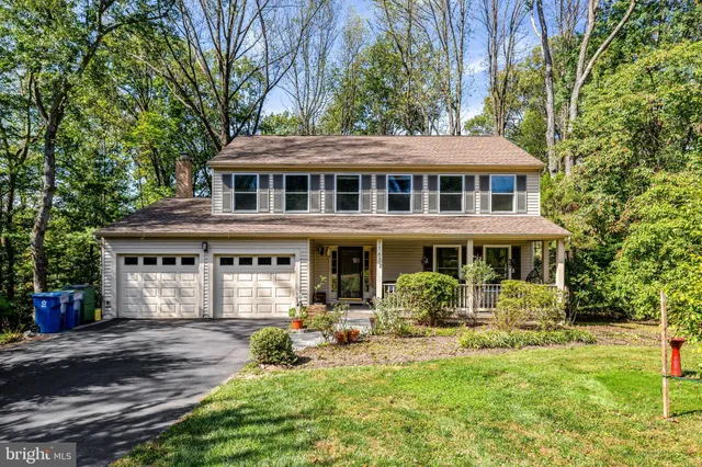 a front view of a house with yard porch and sitting area