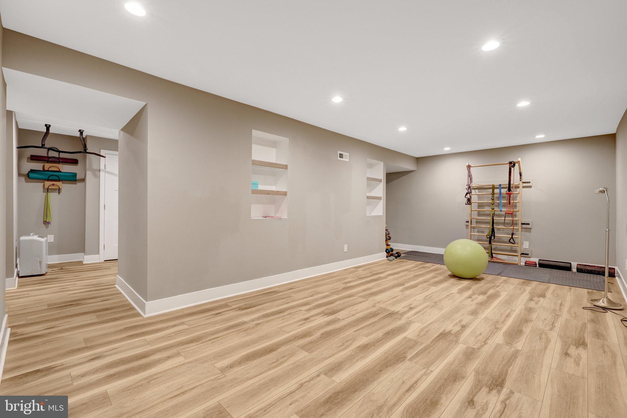 11637 Quail Ridge Court Reston, VA 20194 - Photo 29 of 46 a view of a room with gym equipment and wooden floor