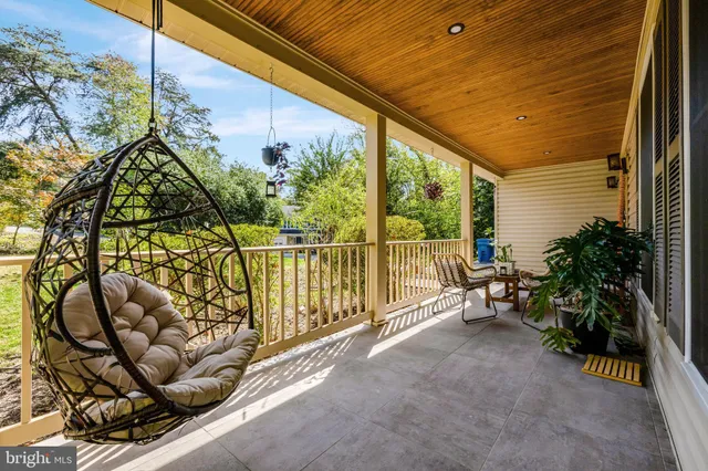 a view of a chairs and table in the balcony