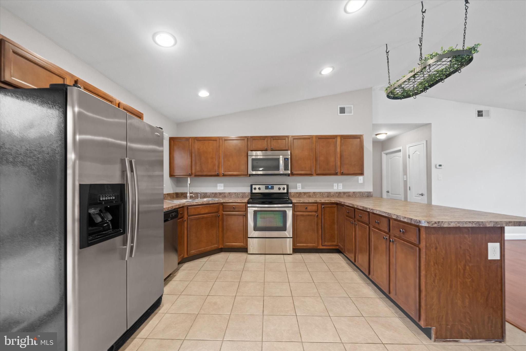 17 Gogh Circle Newark, DE 19702 - Photo 13 of 34 a large kitchen with stainless steel appliances kitchen island granite countertop a refrigerator and a sink