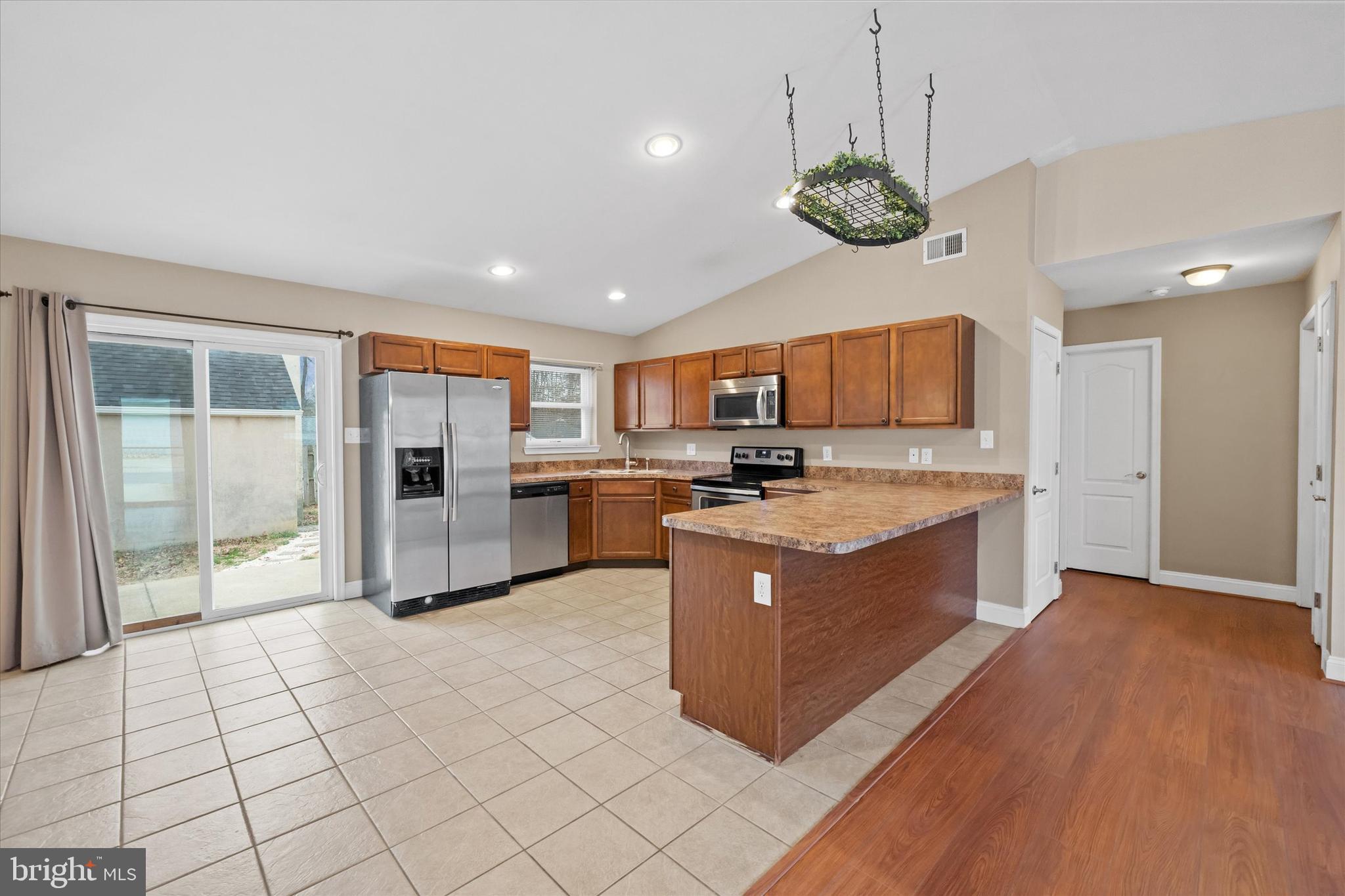 17 Gogh Circle Newark, DE 19702 - Photo 10 of 34 a large kitchen with stainless steel appliances kitchen island granite countertop a stove a refrigerator a sink a microwave and a cabinets