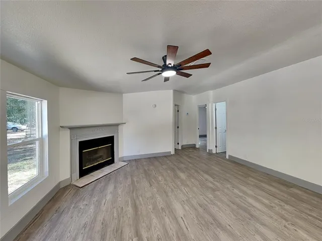wooden floor in an empty room with a fireplace