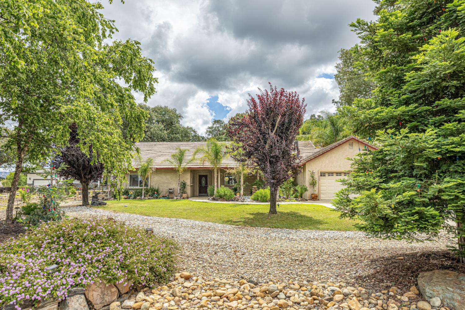 2083 State Rte 26 Valley Springs, CA 95252 - Photo 46 of 59 a front view of a house with a yard and trees