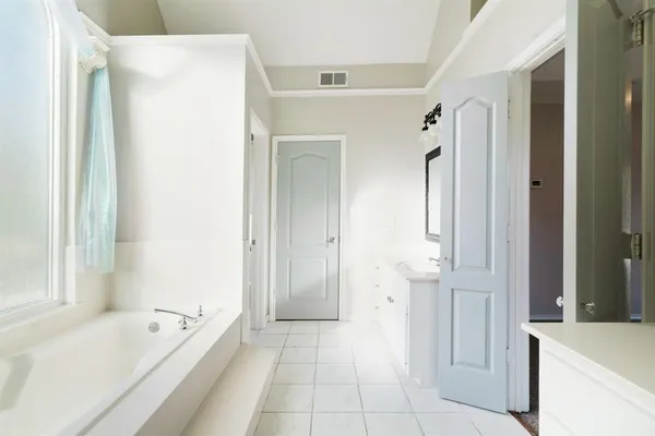 a bathroom with a bathtub and a sink
