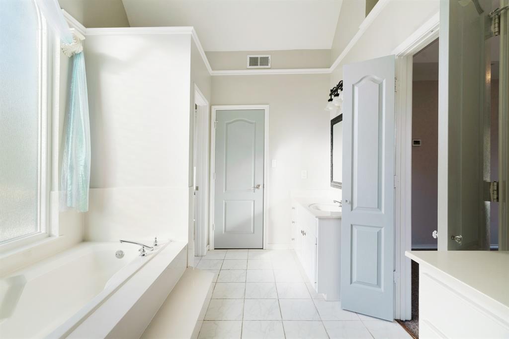 635 Cedar Creek Drive Reno, TX 75462 - Photo 15 of 32 a bathroom with a tub shower and sink