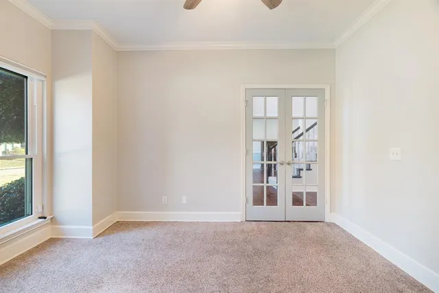 a view of a kitchen with kitchen island a large counter top space stainless steel appliances and a window