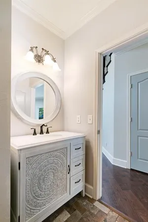 a view of a kitchen with kitchen island a large counter top space stainless steel appliances and a window