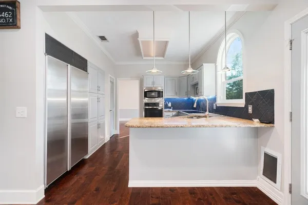 a kitchen with cabinets appliances and a window