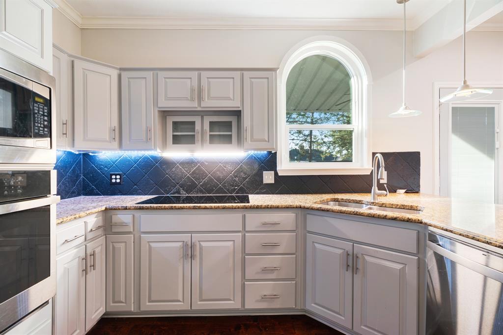 635 Cedar Creek Drive Reno, TX 75462 - Photo 10 of 32 a kitchen with cabinets appliances and a window