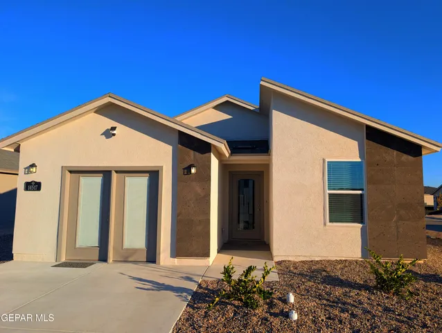 a front view of a house with a garage