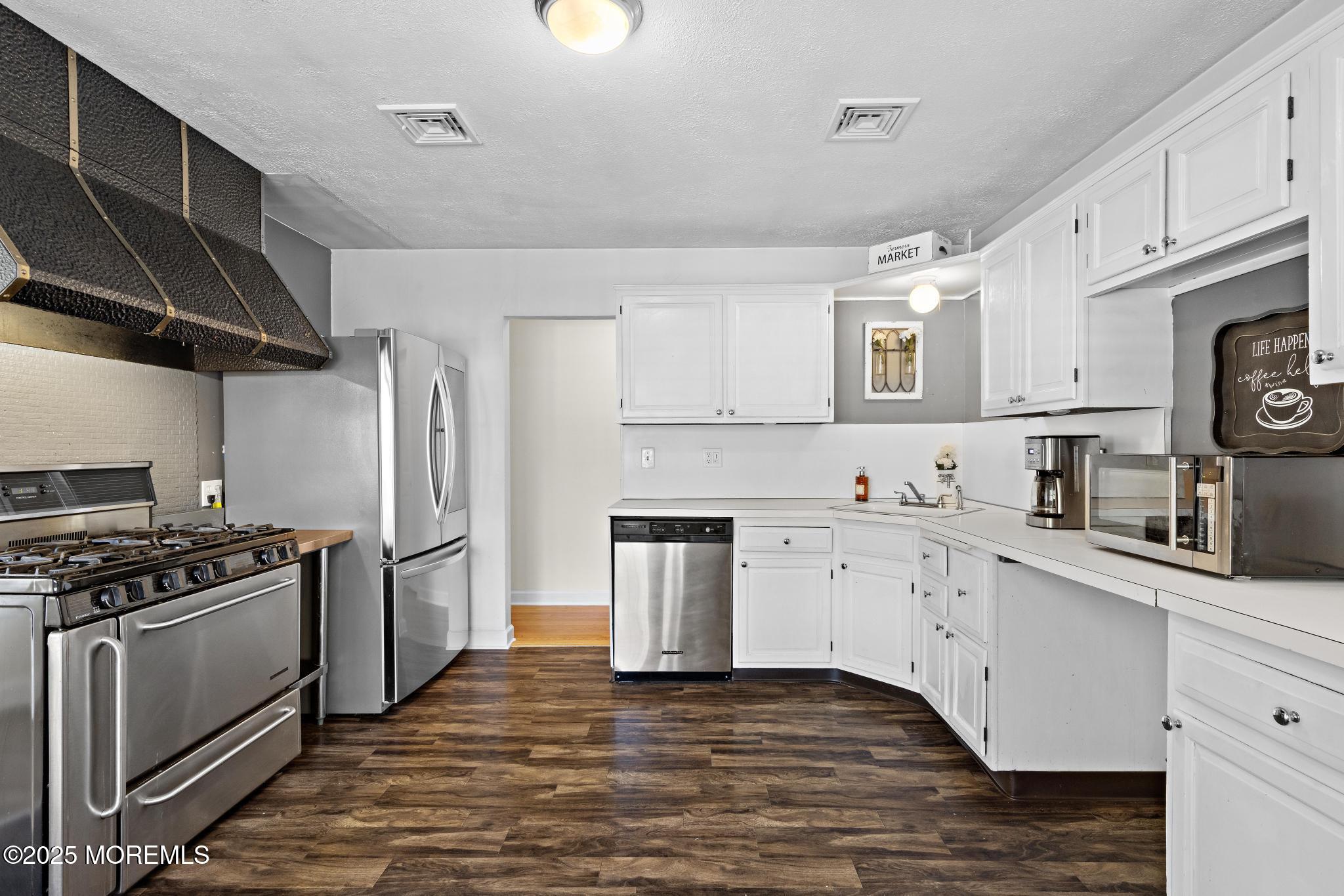 113 Parker Road West Long Branch, NJ 07764 - Photo 27 of 62 a kitchen with stainless steel appliances a stove sink and cabinets