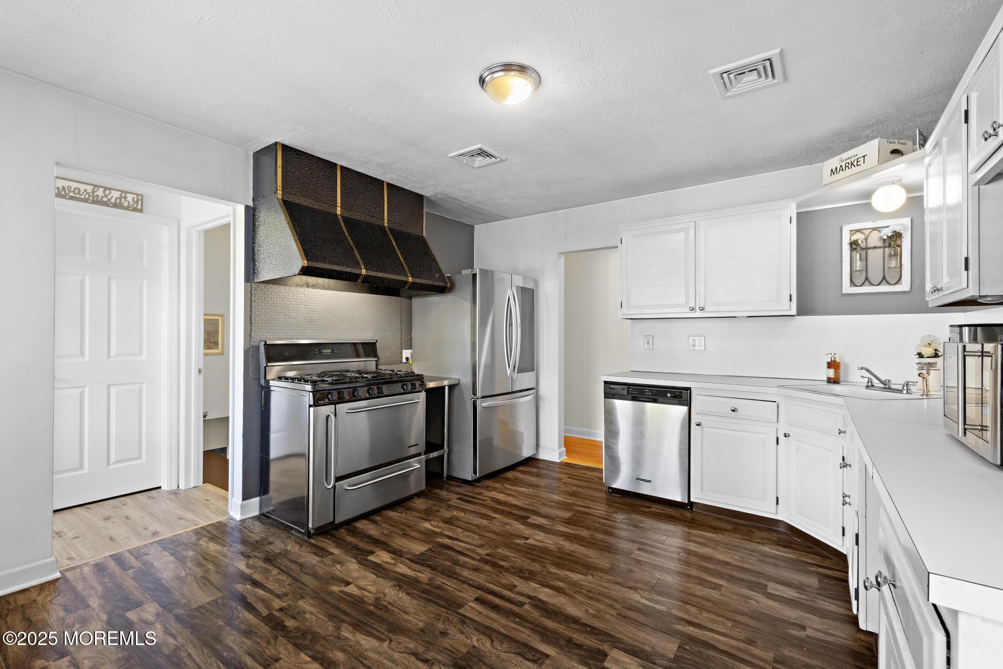 113 Parker Road West Long Branch, NJ 07764 - Photo 28 of 62 a kitchen with granite countertop a stove top oven and sink