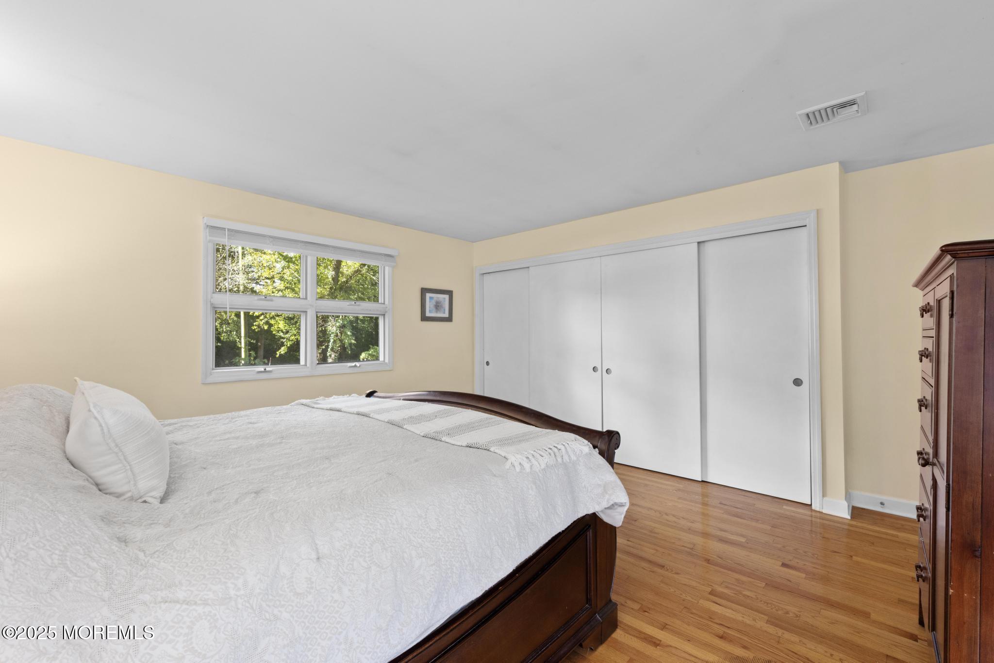 113 Parker Road West Long Branch, NJ 07764 - Photo 36 of 62 a spacious bedroom with a bed and a window