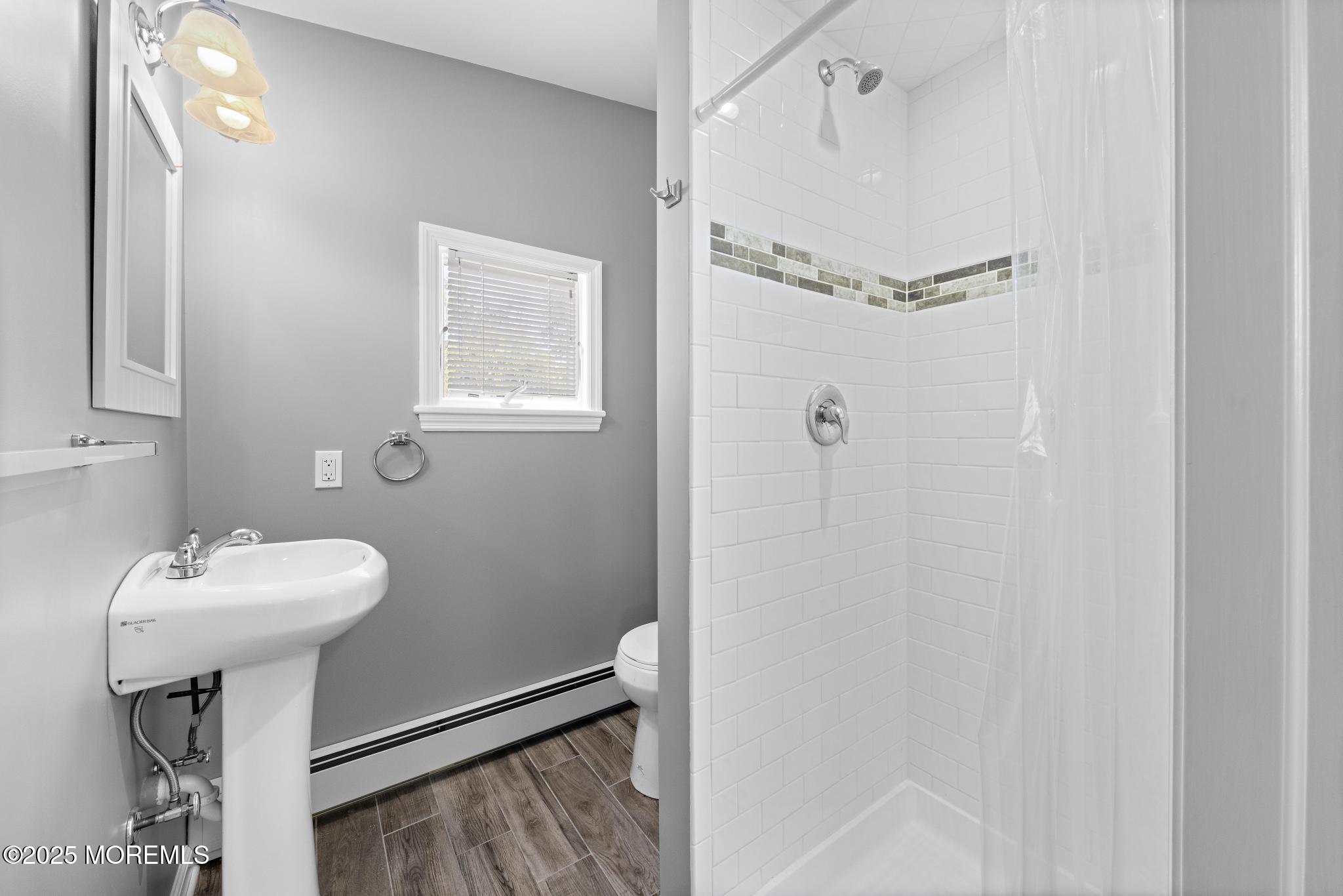 113 Parker Road West Long Branch, NJ 07764 - Photo 47 of 62 a bathroom with a sink a mirror a toilet and shower