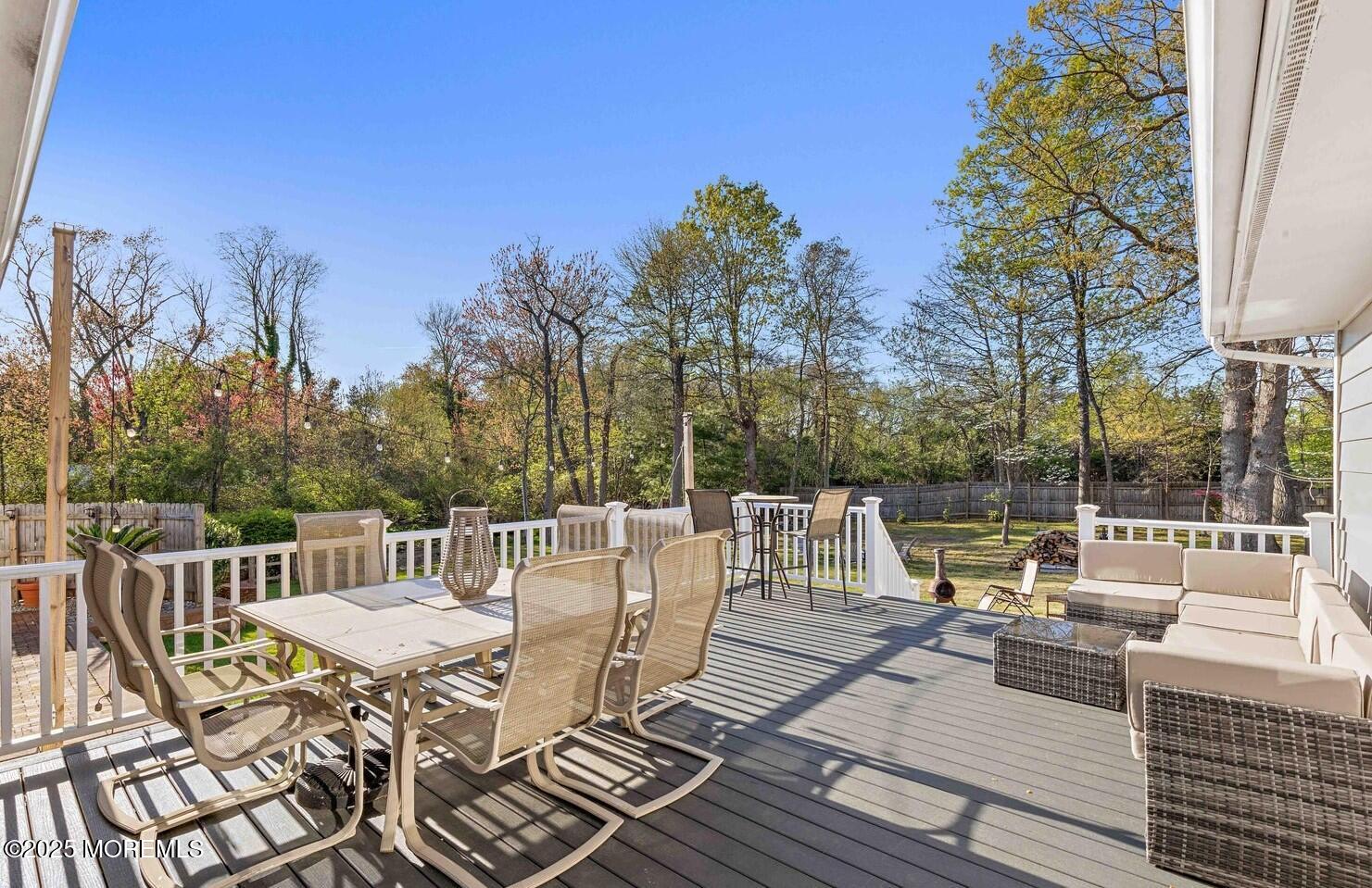 113 Parker Road West Long Branch, NJ 07764 - Photo 48 of 62 a view of a patio with dining table and chairs with wooden floor and fence