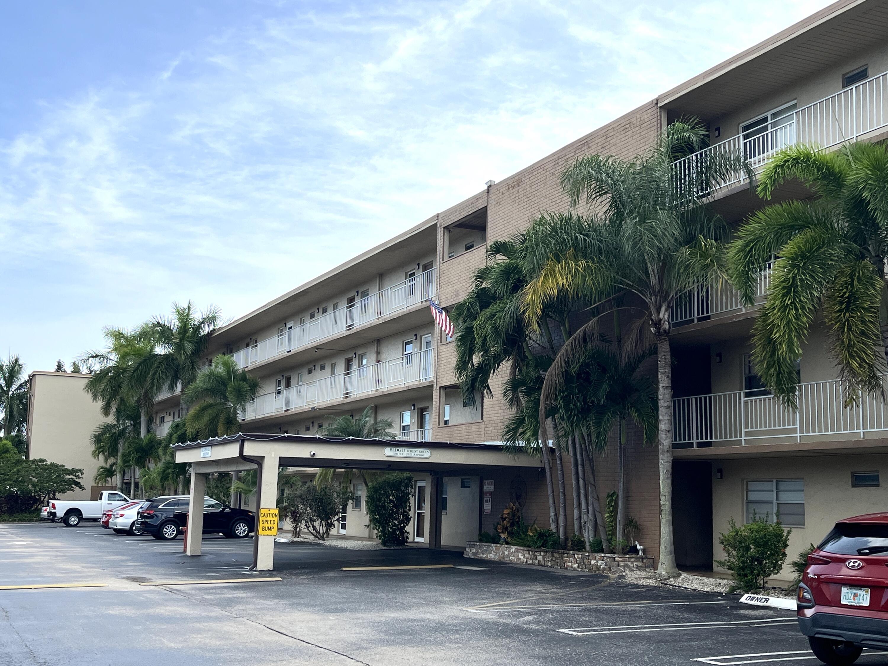 330 Northeast 26th Avenue, Unit 406 Boynton Beach, FL 33435 - Photo 1 of 33 a front view of building with street