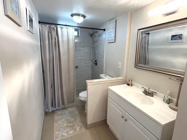 a bathroom with a sink toilet and shower