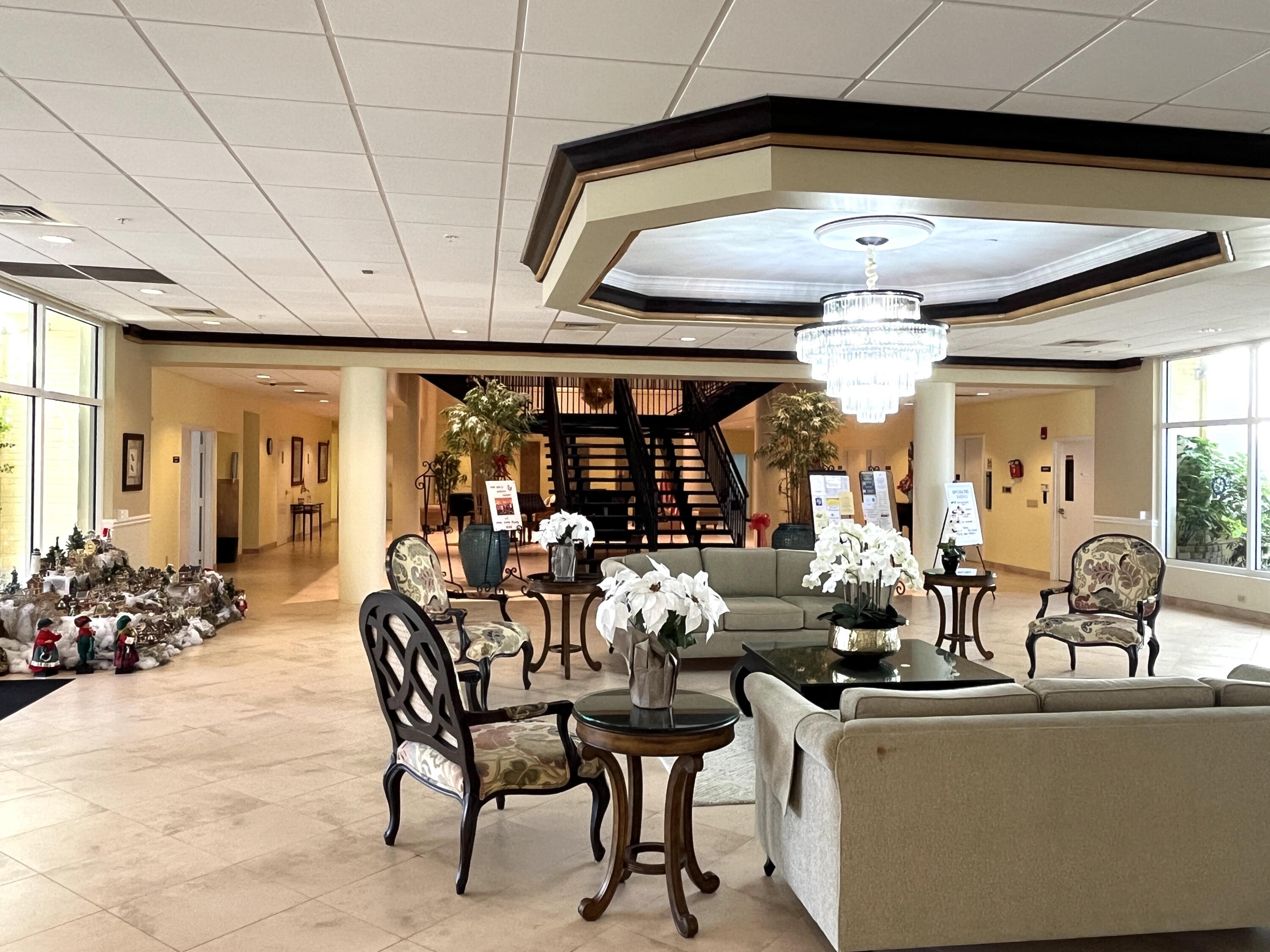 330 Northeast 26th Avenue, Unit 406 Boynton Beach, FL 33435 - Photo 22 of 33 a view of a dining room with furniture and chandelier