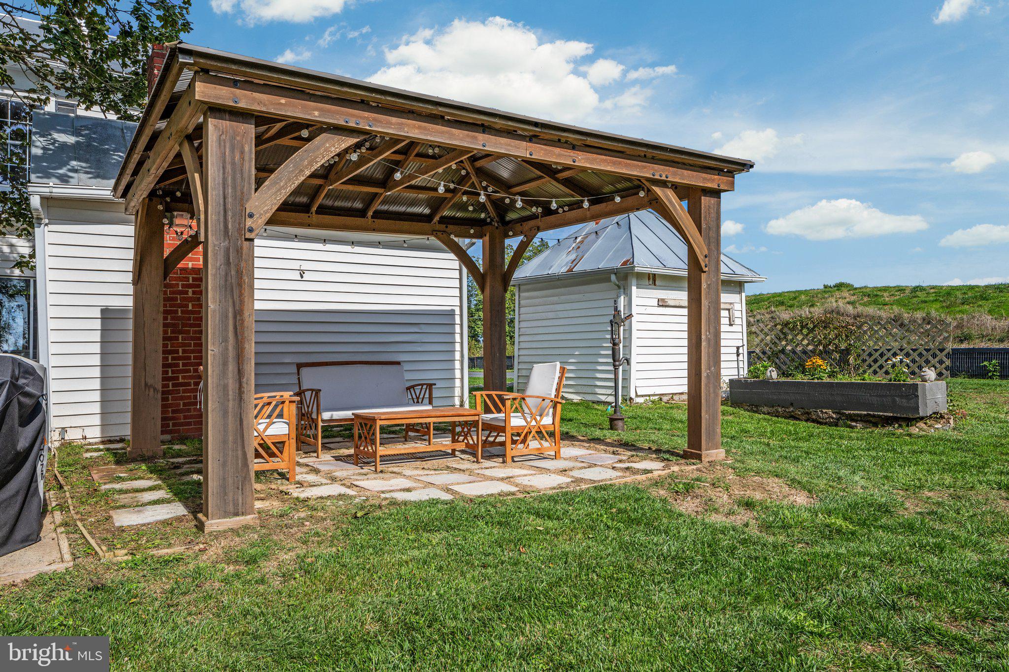 2239 6th Street Middletown, VA 22645 - Photo 37 of 60 a backyard of a house with table and chairs