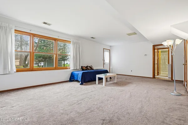 an empty room with windows and ceiling fan