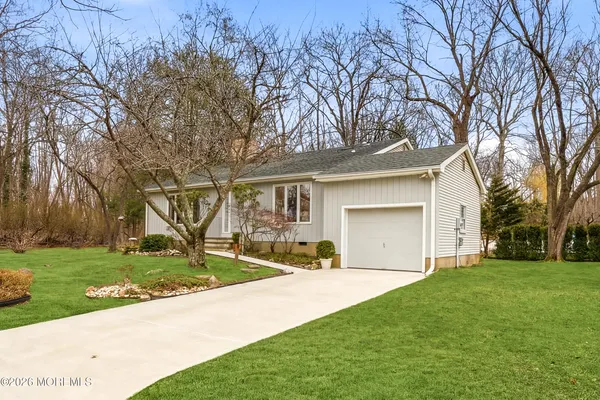 a front view of house with yard and green space