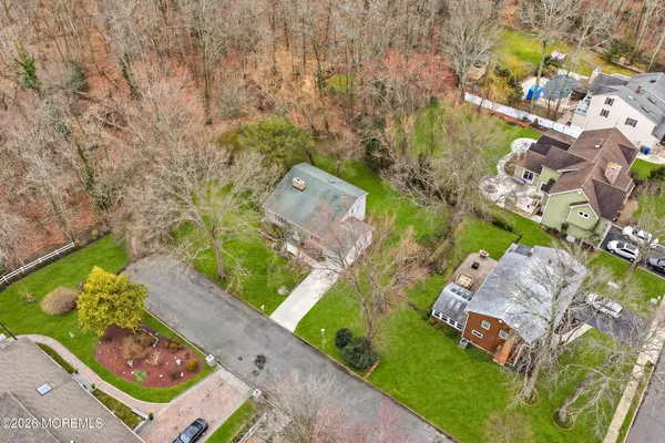 an aerial view of a house with a yard and lake view