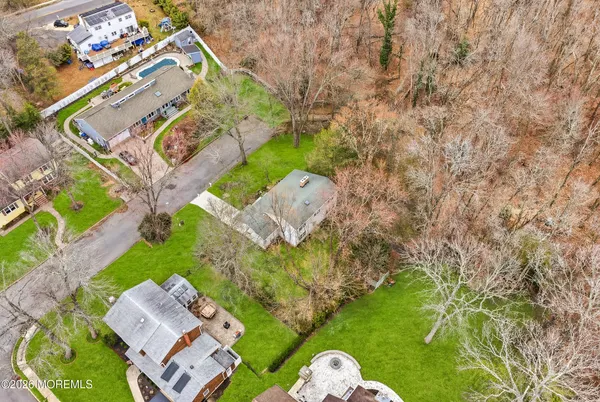 a aerial view of a house with a yard basket ball court and outdoor seating