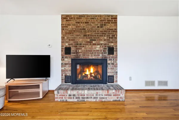 a living room with a flat screen tv and a fireplace