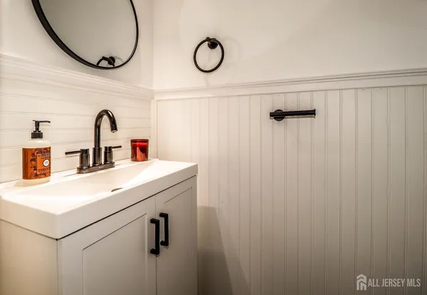a bathroom with a sink a mirror and a shower