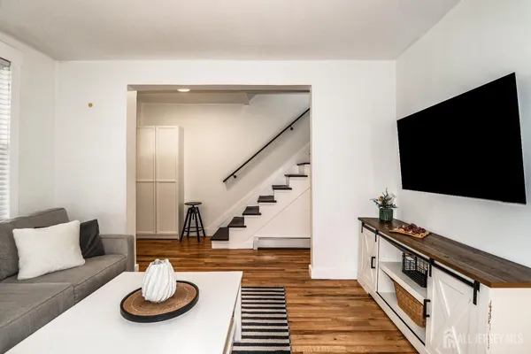 a view of a hardwood floor and an entryway